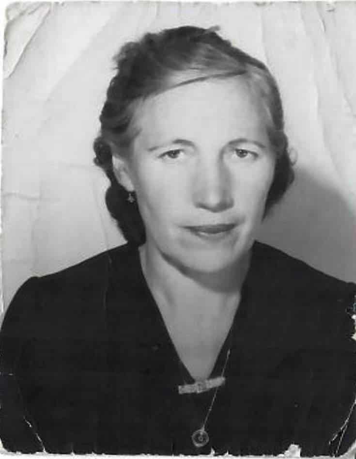 Black and white portrait of Natalia Knezevic's grandmother, Ida. She wears a dark dress and a necklace, and has short, dark wavy hair.