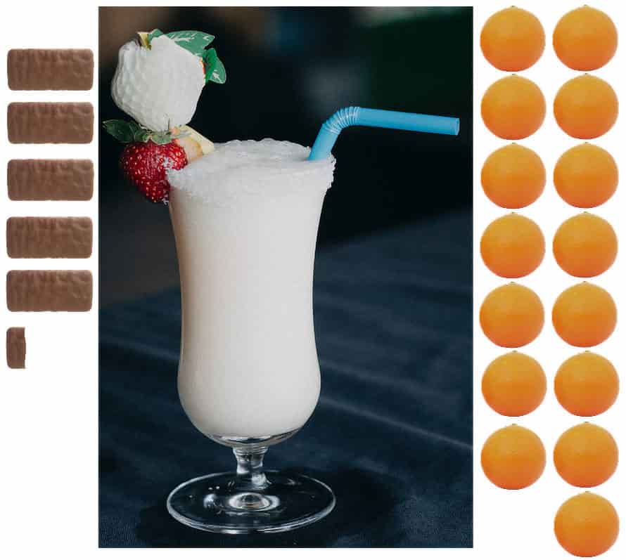 A pina colada in a glass with a blue straw and garnished with a strawberry and a white fruit, surrounded by five 5.3 tim tams and 15 oranges.