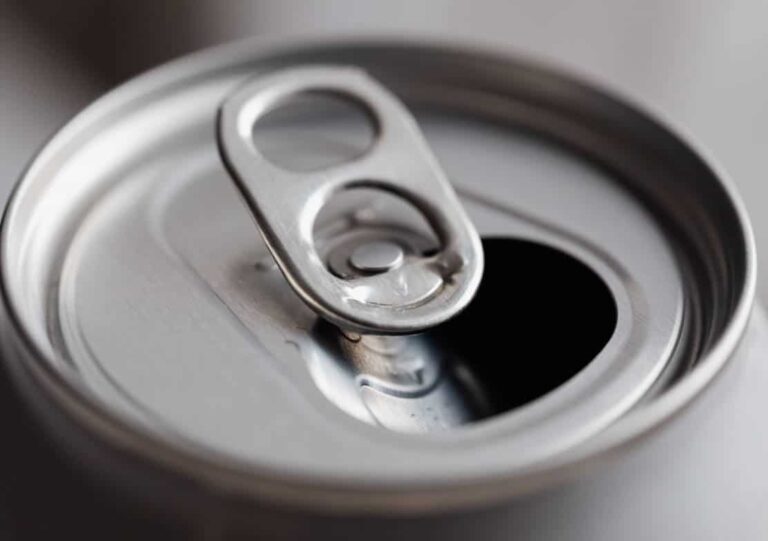 Close-up of an opened aluminum soda can with a pull-tab.